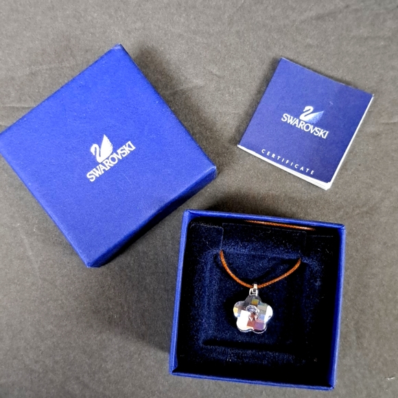 Swarovski Jewelry - Swarovski light purple crystal flower-shaped pendant on a leather cord with box